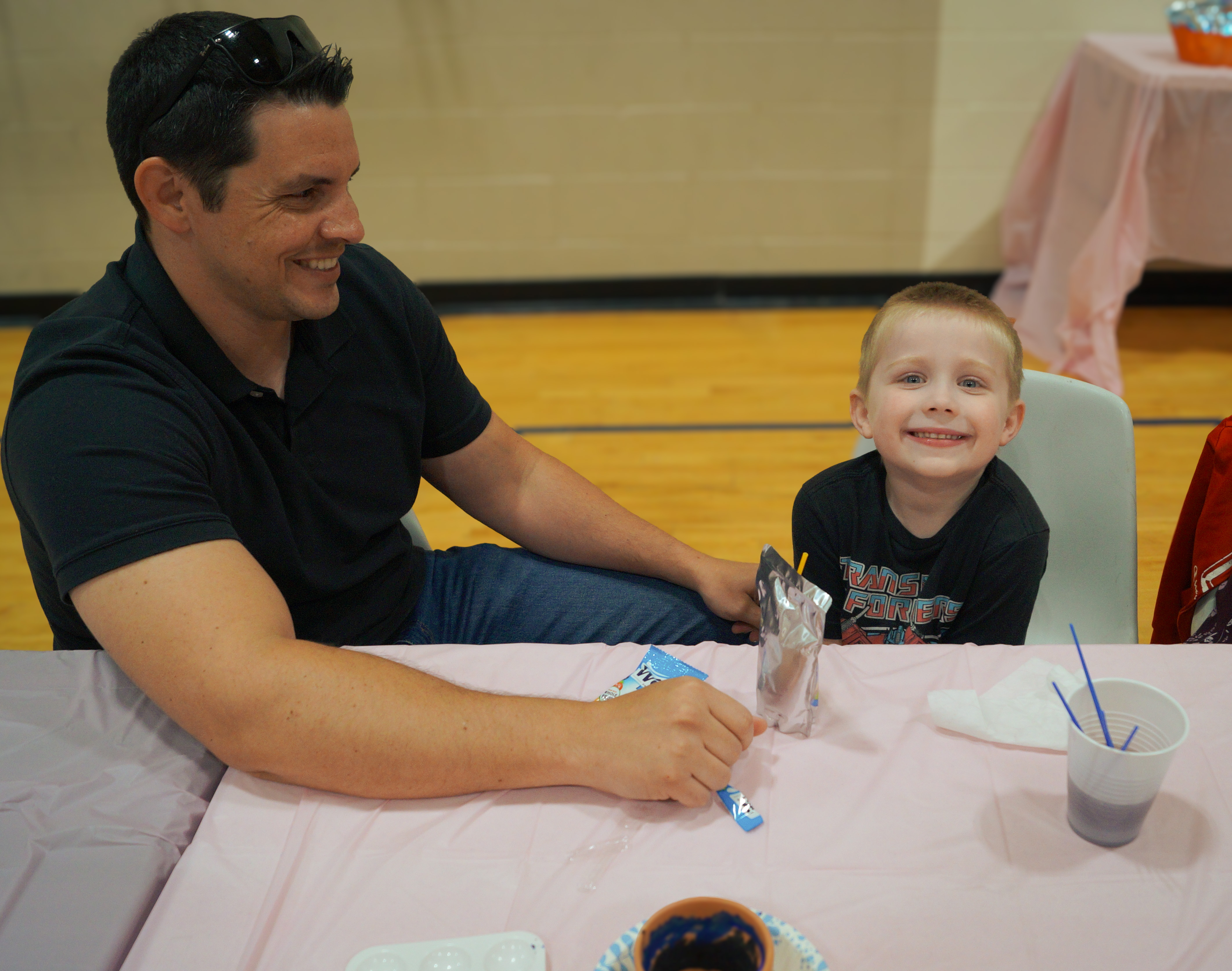 father & son participate in bloom & brush
