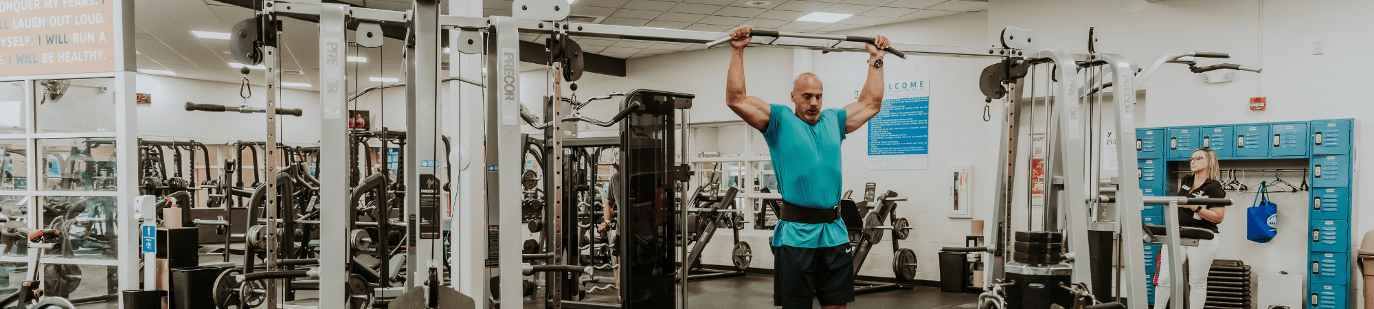 Man doing pull-ups in a gym setting