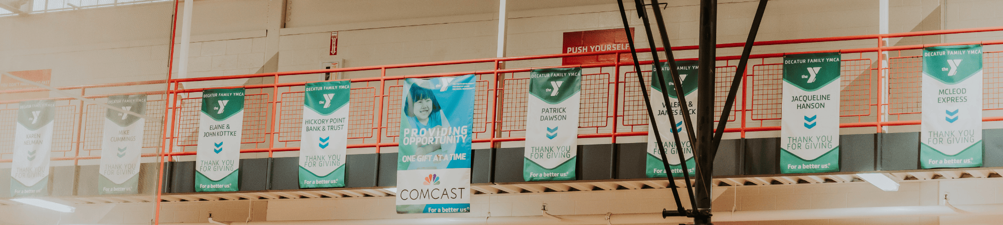 donor banners hanging from a railing in a row
